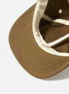 Close-up of the A. SOCIETY x Universal Works Olive Twill Cotton Baseball Hat, showing the olive twill and cream lining on a white background.