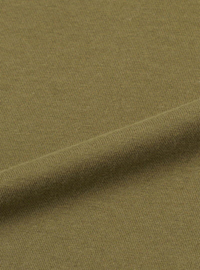 A fabric swatch displaying a close-up texture view of the Walsh x Universal Works Olive Single Jersey T Shirt against a clean white background. The image emphasizes the soft single jersey knit and deep olive green shade.