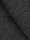 Close-up fabric detail of the grey marl Mowbray Heavy Duty Jacket, showing a densely textured wool-blend surface with tightly coiled fibres and a mix of charcoal and light grey tones. The shot highlights the fabric's thick, tactile pile with soft folds creating depth and shadow.