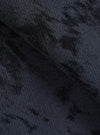 Close-up of the navy and black wool mix fabric of the Be Bop OG Bakers Chore Jacket, showing a tonal camo-style jacquard pattern. The textured, slightly brushed knit surface reveals depth and variation in colour across the folded fabric. No model or background visible.