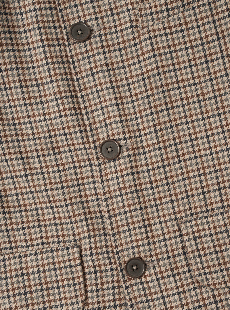 Rear studio shot of the Taupe Lester Dogtooth Franck Jacket displayed on a plain white background. The image focuses on the clean back panel construction, straight hem, and fine taupe houndstooth fabric texture.