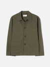 Olive brushed moleskin chore jacket laid flat on a light grey studio backdrop. Features a spread collar, three dark buttons on a placket, one chest patch pocket, and two large patch pockets at the hem. Universal Works woven label visible at the neck. Plain, slightly textured fabric throughout.