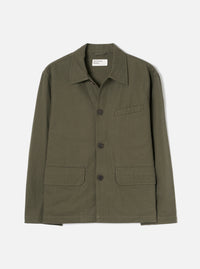 Olive brushed moleskin chore jacket laid flat on a light grey studio backdrop. Features a spread collar, three dark buttons on a placket, one chest patch pocket, and two large patch pockets at the hem. Universal Works woven label visible at the neck. Plain, slightly textured fabric throughout.