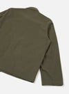 Close-up of the back and right sleeve of an olive brushed moleskin Franck jacket, laid flat on a white studio surface. The smooth, matte fabric shows a plain weave with no visible pattern. A shirt collar is partially visible at the top, and a topstitched hem runs along the bottom edge.