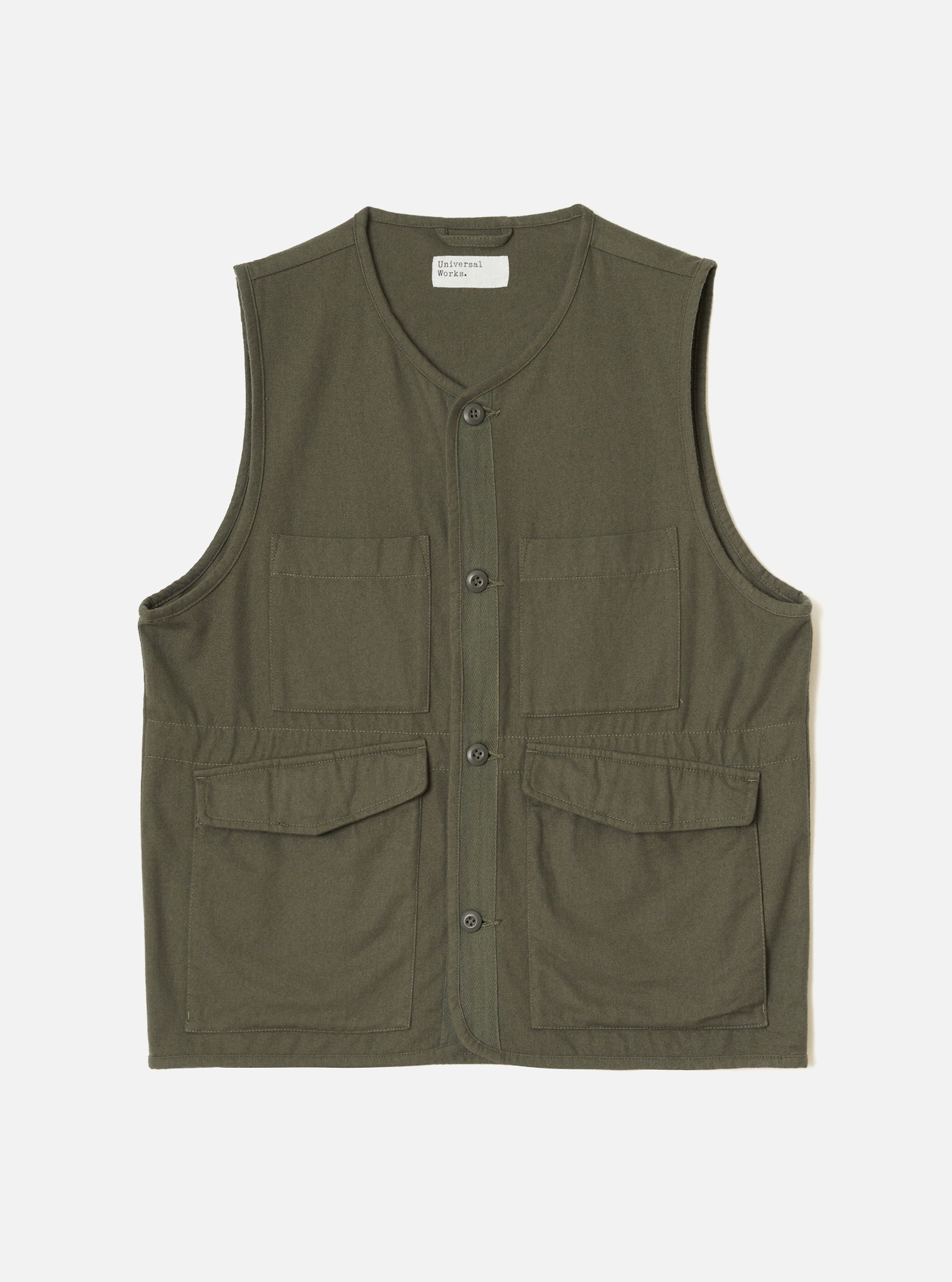Olive brushed moleskin gilet laid flat on a light grey studio backdrop. V-neckline with a Universal Works woven label at the back neck. Four-button placket down the centre front. Two chest patch pockets and two larger flap patch pockets at the lower front. Sleeveless with armhole binding and a straight hem. Visible topstitching throughout.