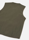 Flat lay of an olive brushed moleskin gilet on a white studio surface, shot from above at an angle. The back of the garment is shown, displaying smooth, matte fabric with a clean sleeveless silhouette, curved armholes, and a straight hem with a small side vent visible at the lower corner.
