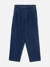 Indigo blue wide-leg denim trousers laid flat on a light grey studio backdrop. The high-rise waistband features belt loops and a single metal button fastening. Double pleats run from the waistband down the front of each leg. The fabric is plain mid-weight denim with visible contrast topstitching at the hem and seams. Full-length legs taper slightly at the ankle.