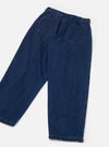 Flat lay of indigo work denim Dutch pants on a light grey seamless backdrop, shot from the back. Wide-leg silhouette with a high waist, two large patch pockets with topstitching, brass side-adjustor buttons at the waistband, and contrast orange stitching at the hems. Plain-woven mid-weight denim in deep indigo blue.
