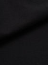 Close-up of black brushed moleskin fabric, showing a dense, soft-napped texture with gentle folds creating subtle shadow and depth across the surface.