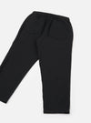 Black brushed moleskin hi-water trousers laid flat on a white studio surface, shot from the back. The elasticated waistband with a visible drawcord is prominent at the top. Two large patch pockets sit on the rear. The tapered legs end in a cropped, unfinished hem. Plain, smooth fabric with a subtle matte finish.