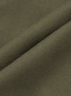 Close-up detail shot of olive brushed moleskin fabric, showing a folded edge that highlights the fine knit texture and soft surface finish. The solid, muted khaki-green cloth has a dense, smooth hand visible across the fold. No background is visible.