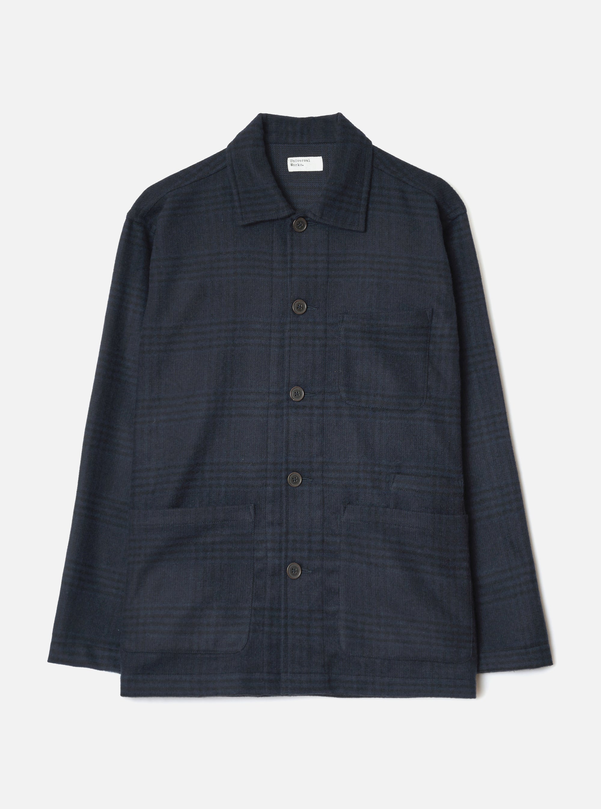 Navy wool mix bakers overshirt in a tonal check pattern, shot flat on a white studio backdrop. Features a spread collar, five dark horn-effect buttons down the centre front, one chest patch pocket, and two large lower patch pockets. Long sleeves with plain cuffs. A Universal Works woven label sits at the neck.