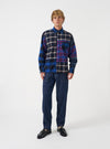 A model wearing the Indigo Future Denim Troopers Fatigue Pant, shown from the front. The indigo denim trousers feature utility fatigue styling, spacious leg pockets, and a relaxed cut set against a plain background.