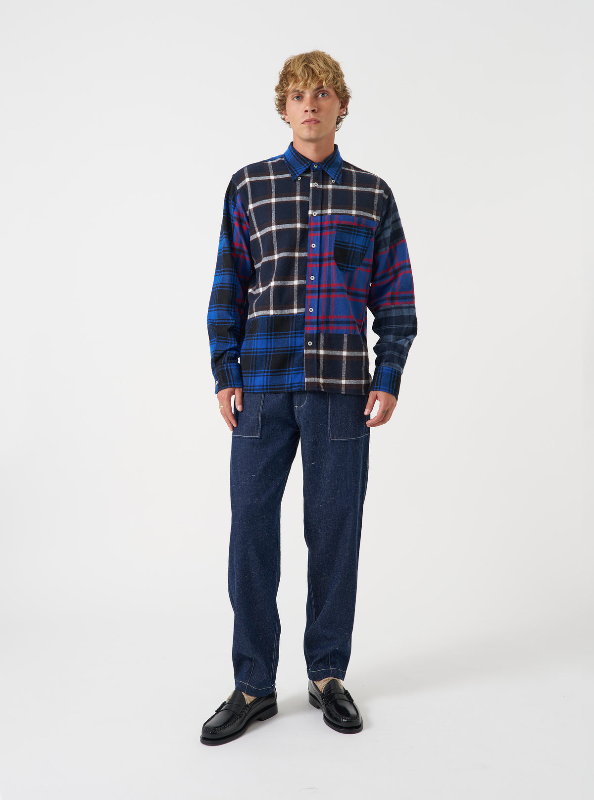 A model wearing the Indigo Future Denim Troopers Fatigue Pant, shown from the front. The indigo denim trousers feature utility fatigue styling, spacious leg pockets, and a relaxed cut set against a plain background.