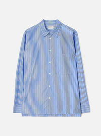 Blue and white vertical stripe long-sleeve shirt laid flat on a light grey studio backdrop. Features a point collar, central button placket with white buttons, a single patch chest pocket, and buttoned barrel cuffs. A Universal Works woven label is visible at the neck. Smooth cotton fabric with a crisp finish.