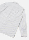 Flat lay of the grey stripe compact cotton Lucky Shirt, showing the back panel and one long sleeve. Blue pinstripes run vertically on a white-grey ground. A back yoke seam is visible at the shoulder. The cuff features two white buttons and sits fully extended. Light grey seamless studio backdrop.