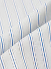 Close-up fabric shot of the grey stripe compact cotton used in the Lucky Shirt. Two folded layers of cloth overlap diagonally, showing a white base with vertical blue and grey pinstripes in a repeating grouped pattern. The fine woven texture is clearly visible against a plain white background.