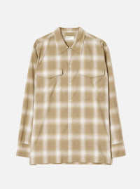 Sand and cream ombre check long-sleeve shirt laid flat on a light grey studio backdrop. Features a pointed collar, full-length button placket with cream buttons, two flap chest pockets, and buttoned cuffs. Universal Works woven label visible at the neckline.