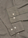 Close-up flat lay of the Sand/Olive Parker Check Attendant Shirt, showing the button placket with four pearlescent buttons and a chest patch pocket with a pointed flap. The fabric features a fine micro-check pattern in sand, olive, and dark brown. No model or mannequin present.