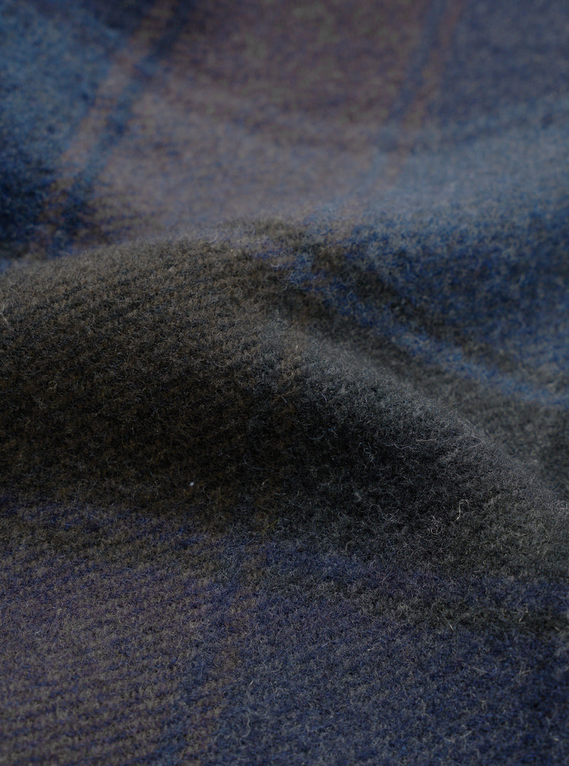 A close-up fabric swatch image of the Universal Works Navy/Brown Berlin Wool Check Account Coat, showcasing the rich textured weave of the navy, brown, and grey checkered wool blend fabric.