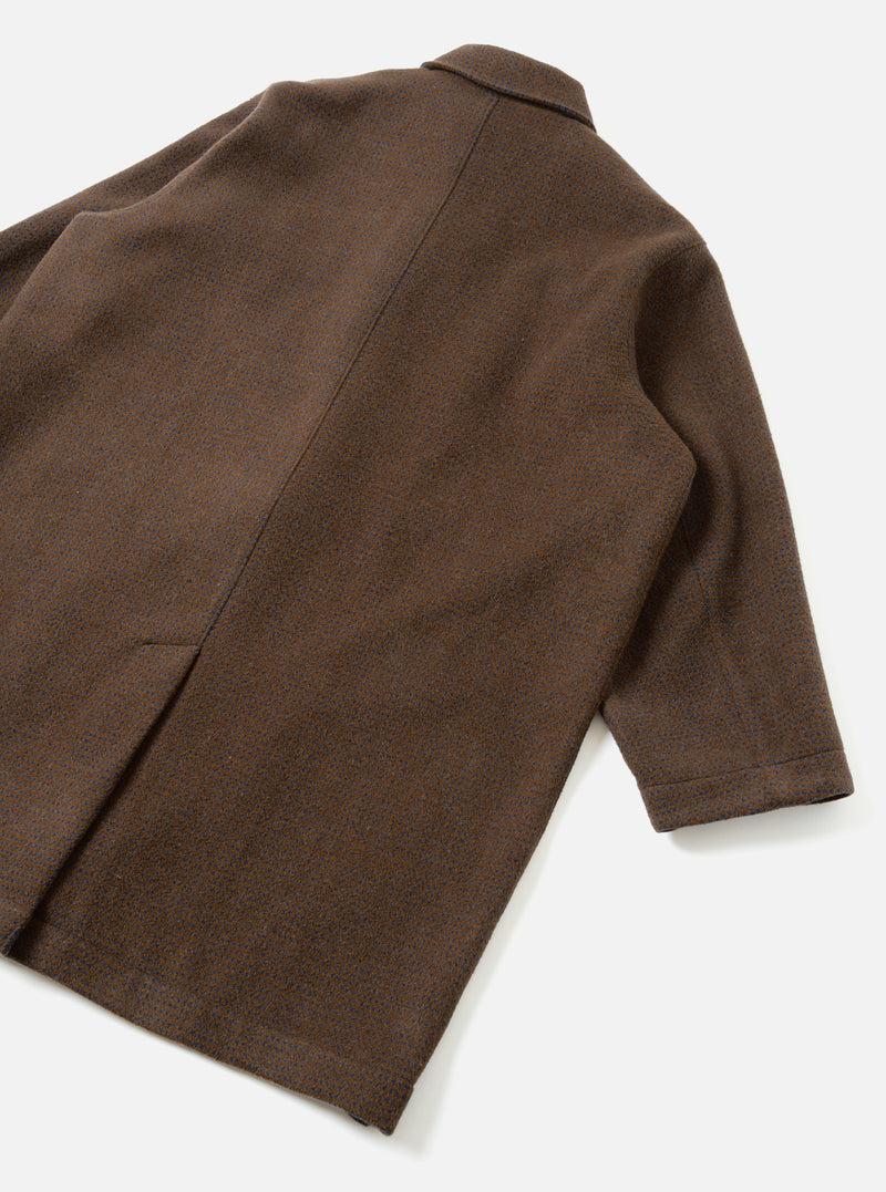 A studio back view of the Navy/Brown Wool Tweed Mix Stan Coat shown on a neutral backdrop. The rear panel emphasizes the tailored shoulders, straight hemline, and textured navy and brown wool tweed mix fabric without pocket details.
