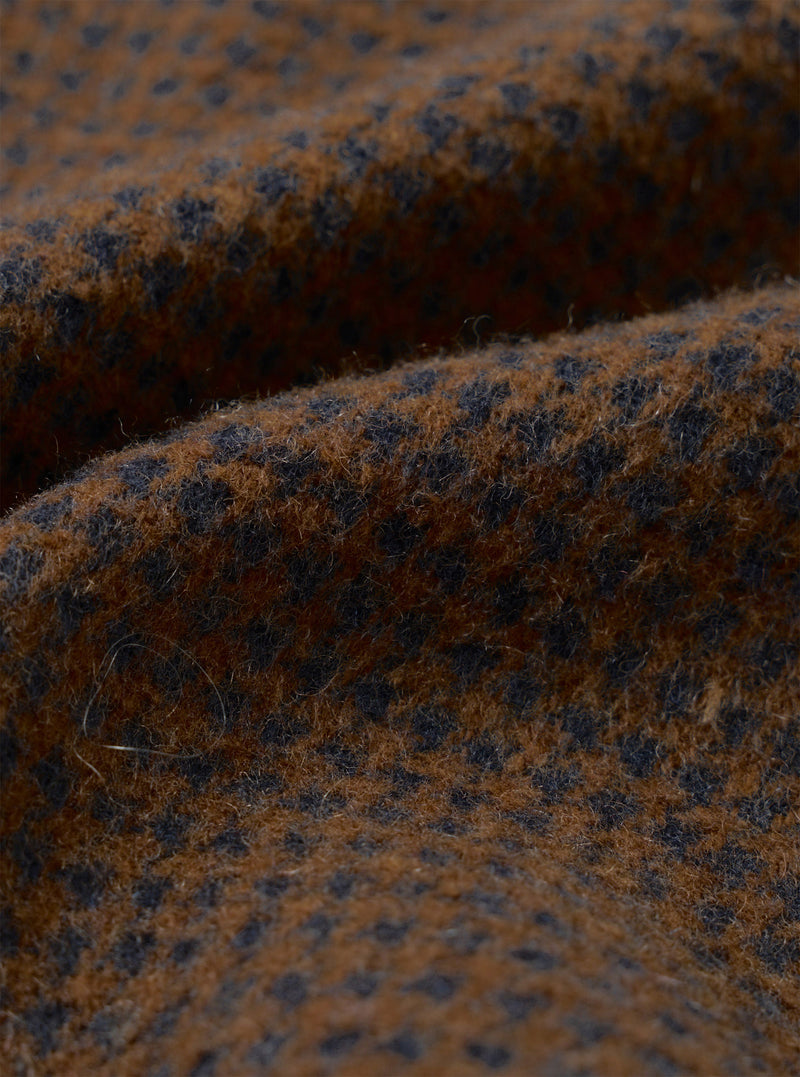 A close-up swatch image of the fabric used for the Navy/Brown Wool Tweed Mix Stan Coat on a white background. The shot details the tight weave pattern, rich texture, and mixed dark navy blue and earthy brown yarn composition.