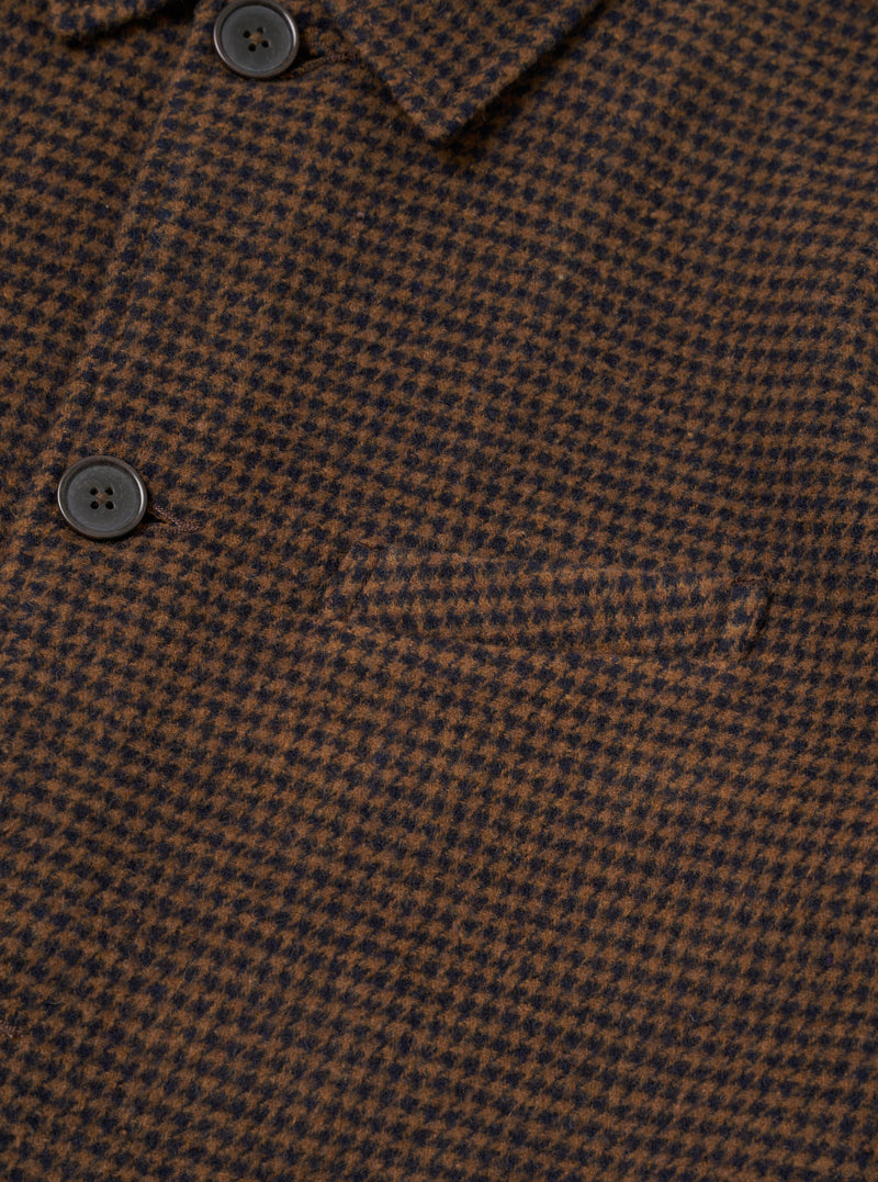 A close-up detail shot focusing on the collar, zip closure, and chest pocket of the Navy/Brown Wool Tweed Mix Franck Jacket against a plain background. The fine weave of the dark blue and brown wool tweed fabric is clearly visible.