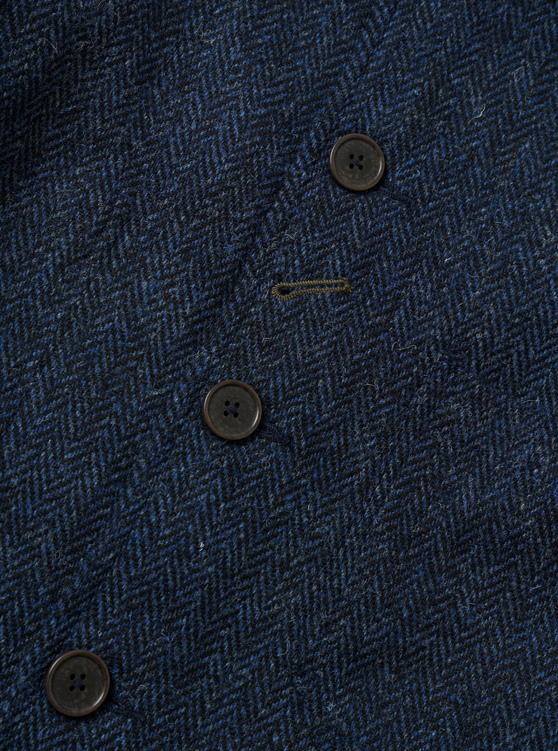A close-up detail shot of the Blue/Black Harris Tweed OG Bakers Chore Jacket against a plain background. The image highlights the rich tweed texture, front button placket, and fine stitching along the collar and pocket.