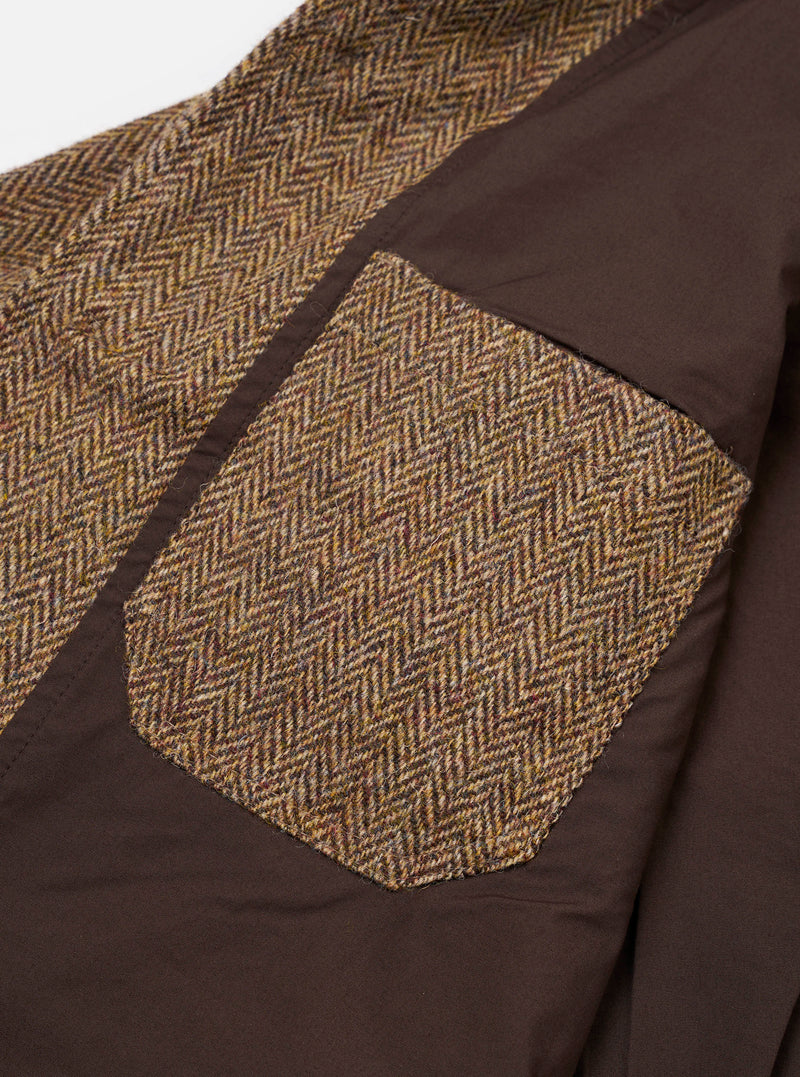 Close-up view of the lower patch pocket on the Sand/Brown Harris Tweed OG Bakers Chore Jacket against a plain background, emphasizing the tweed fabric texture, seam details, and button accent.