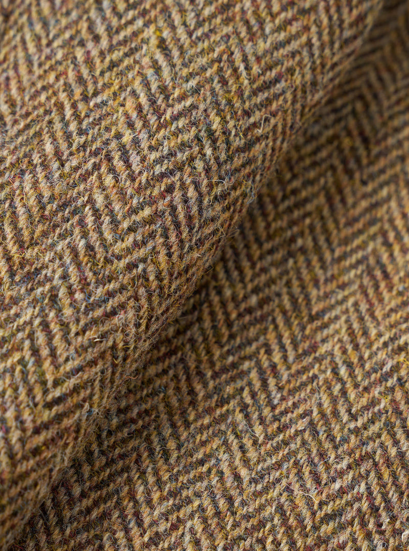 A detailed fabric swatch image of the Sand/Brown Harris Tweed OG Bakers Chore Jacket, showcasing the woven texture, pattern, and color tone of the natural sand and brown Harris Tweed wool.
