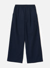 Navy wool herringbone wide-leg trousers laid flat on a plain light grey backdrop. The elasticated waistband features a single dark metal button at the centre front. Two side slash pockets sit at the hips. The fabric has a subtle herringbone texture throughout. Full-length legs with a wide, relaxed silhouette and plain hem.