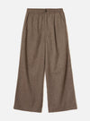Brown wool herringbone wide-leg trousers laid flat on a plain white background. The elasticated waistband features a single dark button at centre front. Slanted side pockets sit below the waistband. The fabric shows a classic herringbone weave in brown and cream tones. Full-length legs with a generous wide leg and plain hem.