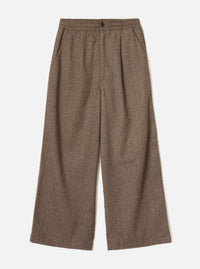 Brown wool herringbone wide-leg trousers laid flat on a plain white background. The elasticated waistband features a single dark button at centre front. Slanted side pockets sit below the waistband. The fabric shows a classic herringbone weave in brown and cream tones. Full-length legs with a generous wide leg and plain hem.
