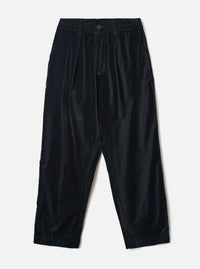 Black velvet Oxford trousers laid flat on a light grey seamless backdrop. The wide-leg, tapered silhouette features a double-pleated front, elasticated waistband with a single button fastening, and side seam pockets. The fine-wale velvet fabric has a subtle sheen. Hem is plain and unfinished at the ankle.