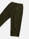 Olive velvet corduroy trousers laid flat on a light grey seamless surface, shot at an angle. The elasticated waistband is visible at the top, with two buttoned flap pockets at the front and a single button-fastening welt pocket at the rear. The legs taper slightly toward plain, unfinished hems.