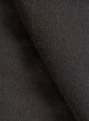 Close-up of the black single jersey knit fabric, showing a fine, even knit texture with a soft, slightly brushed surface. The fabric is folded to reveal depth and drape. No garment details or background are visible.