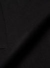 Close-up detail shot of the black Mowbray Mac Coat fabric. The tightly woven wool-blend cloth has a soft, lightly felted texture with a matte finish. A curved seam line is visible along the left edge, with fine topstitching. No background is visible.