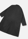 Grey marl wool-blend mac coat laid flat on a white studio surface, showing the back. A centre back seam runs the full length with a vent at the hem. Notched collar visible at the top. Plain cuffs at sleeve ends. Fabric has a fine mélange texture throughout.
