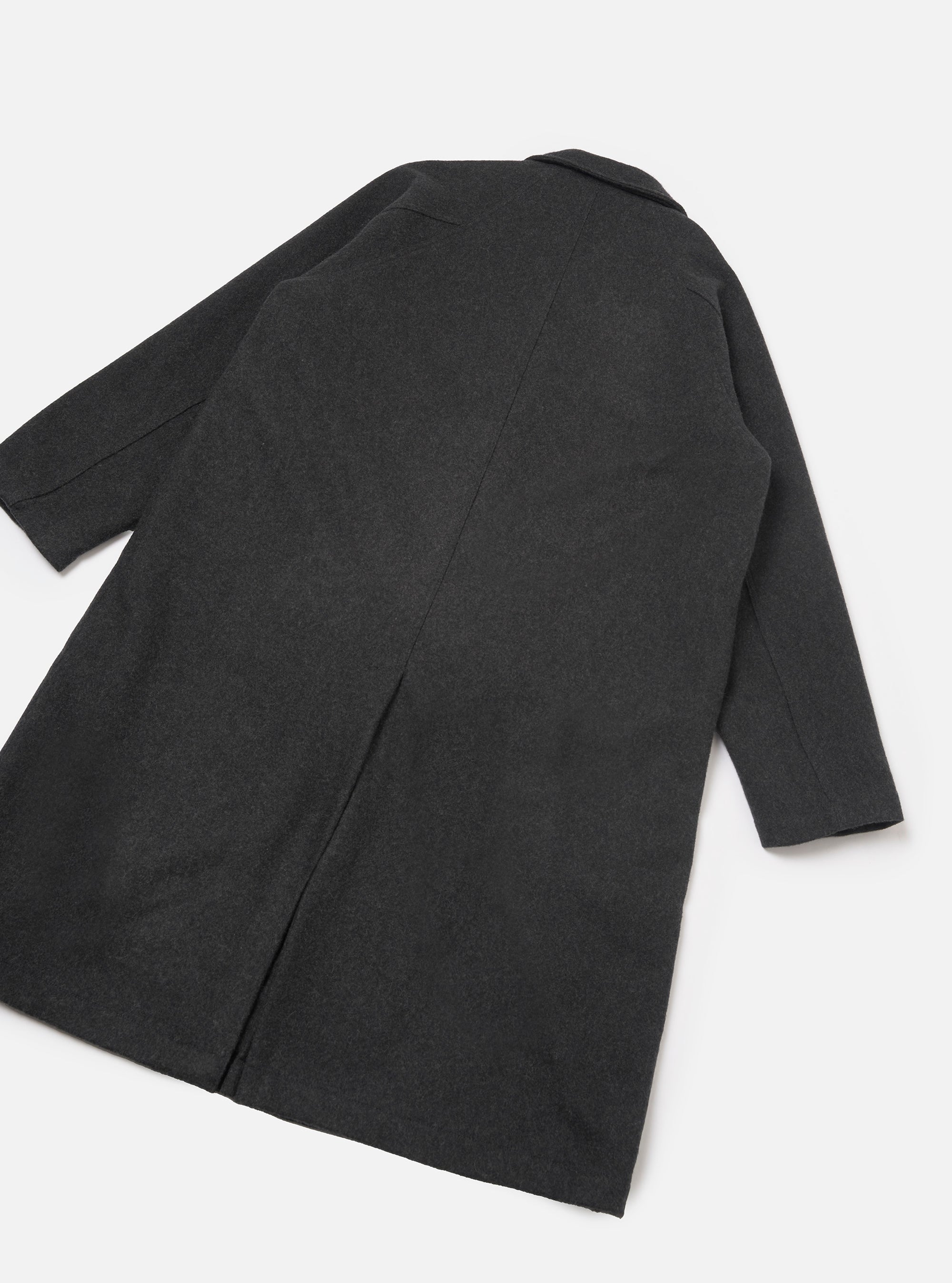Grey marl wool-blend mac coat laid flat on a white studio surface, showing the back. A centre back seam runs the full length with a vent at the hem. Notched collar visible at the top. Plain cuffs at sleeve ends. Fabric has a fine mélange texture throughout.