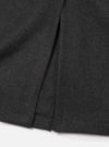 Close-up of the back hem and centre vent of a grey marl wool mac coat, laid flat on a white surface. The mélange fabric has a soft, lightly textured finish. The vent opening and neat hem are clearly visible, showing clean topstitching and precise construction.