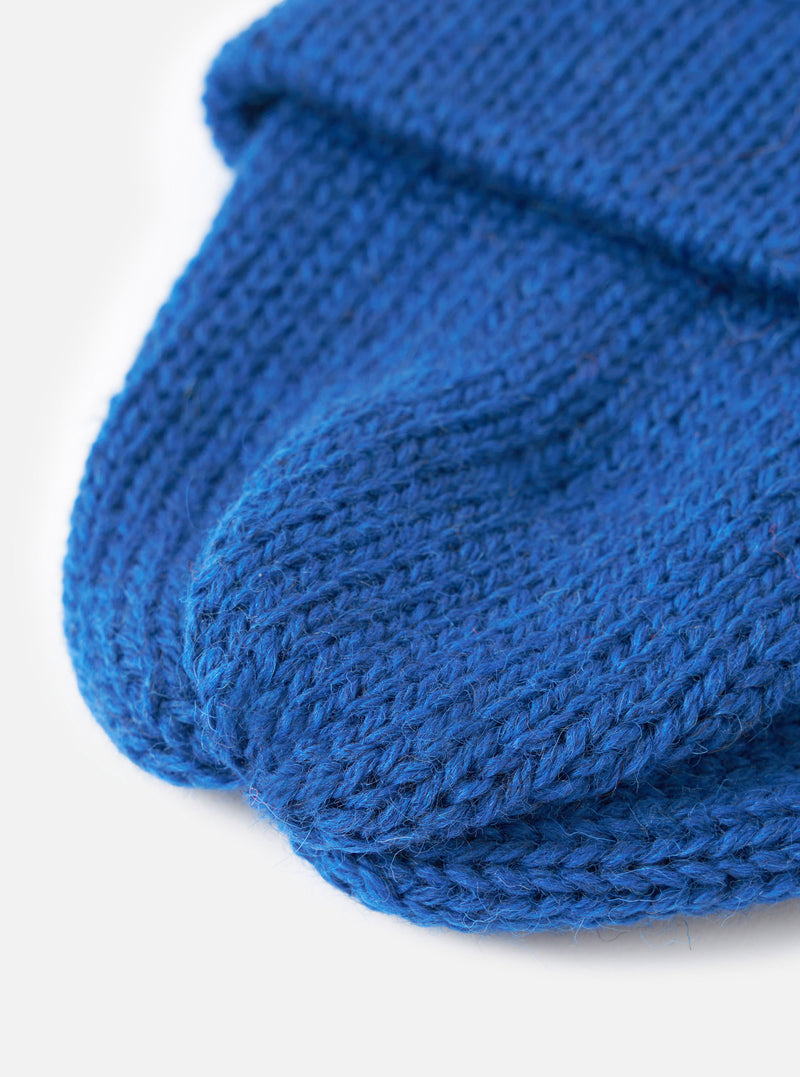 A close-up view of the Bright Navy British Wool Short Watch Cap on a plain background, focusing on the fine texture of the pure British wool yarn and the pinched crown construction details.