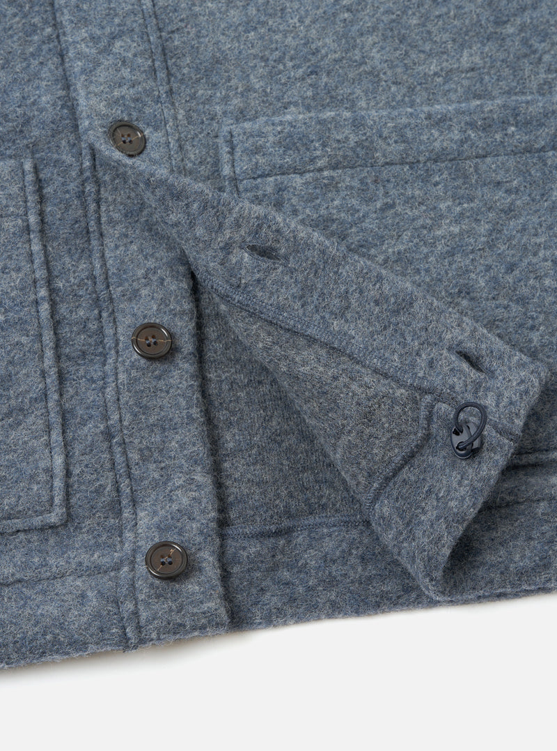A close-up detail view of the Slate Blue Wool Fleece Advance Cardigan against a plain background, focusing on the button placket, chest patch pocket, and textured slate blue wool fleece material.
