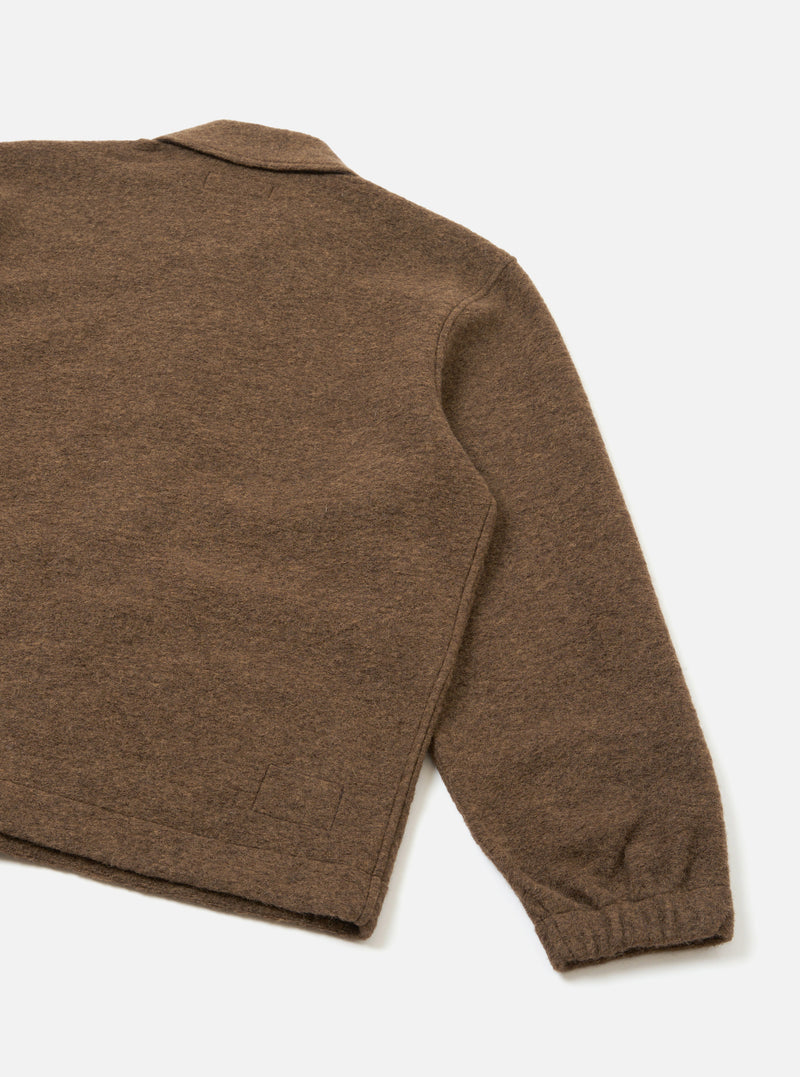 A back view of the Brown Marl Wool Fleece Rams Jacket shown against a plain studio background. The minimalist design highlights the clean shoulder seams, straight hem, and textured marled wool fabric.