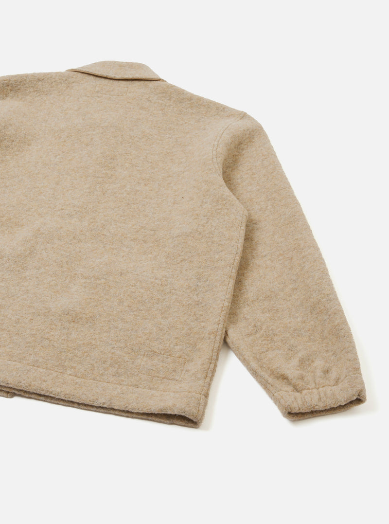 A rear view of the Fawn Wool Fleece Rams Jacket laid flat on a plain backdrop. The simple design emphasizes the straight hem, clean shoulder construction, and warm cream fawn wool fleece fabric texture.