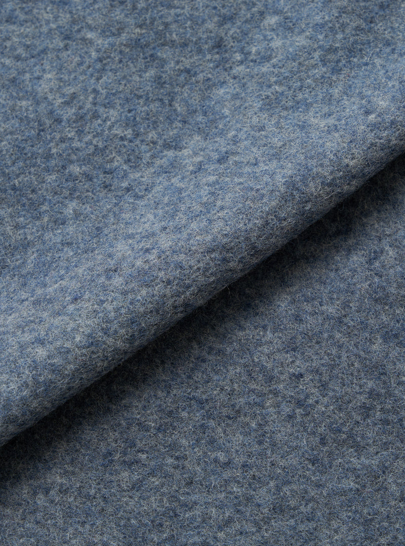 A close-up fabric swatch image of the Slate Blue Wool Fleece Rams Jacket on a neutral background, displaying the thick fleece texture and deep slate blue color of the insulating wool-blend material.