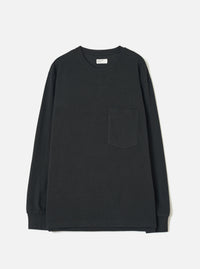 Black long-sleeve pocket tee in a recycled wool mix, laid flat on a light grey studio backdrop. Features a ribbed crew neck with a woven label at the back, a single patch pocket on the left chest, ribbed cuffs, and a plain hem. The jersey fabric has a smooth, mid-weight texture throughout.