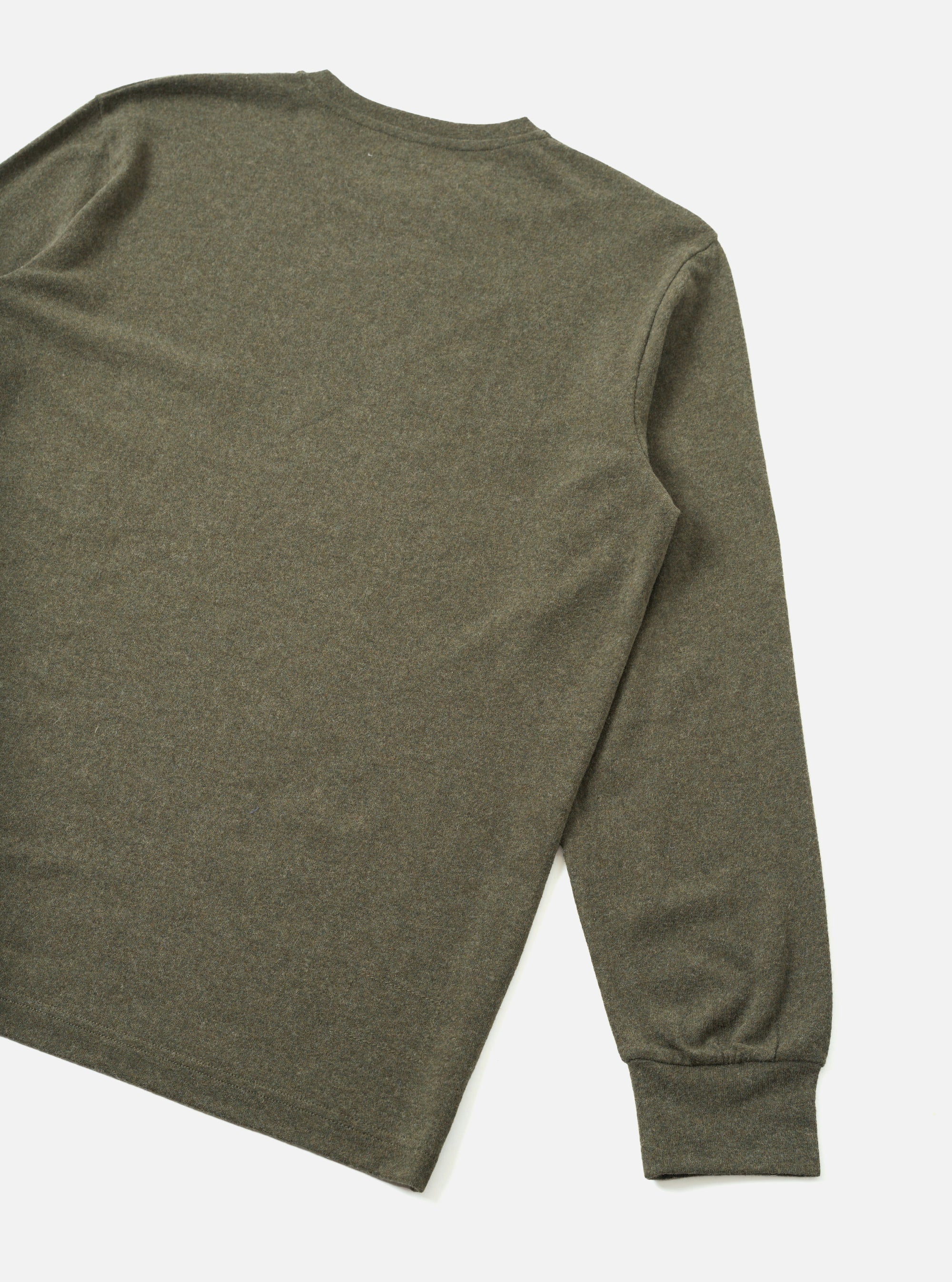 Rear three-quarter flat lay of an olive marl long-sleeve pocket tee on a plain white studio surface. The shot shows the back panel and right sleeve in full, with a crew neckline visible at the top. The ribbed cuff is clearly visible at the sleeve end. Fabric has a heathered wool-mix texture throughout.