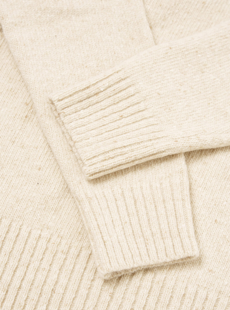 A detailed close-up image of the Fawn Wool Fleck Roll Neck collar, displaying the intricate ribbed knit structure and soft recycled wool texture accented with subtle multi-colored flecks.
