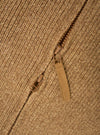 A close-up detail shot of the Tawny Eco Wool Zip Cardigan against a plain white studio background. The image highlights the rich tawny brown eco wool knit fabric, zipper hardware, and detailed collar stitch construction.
