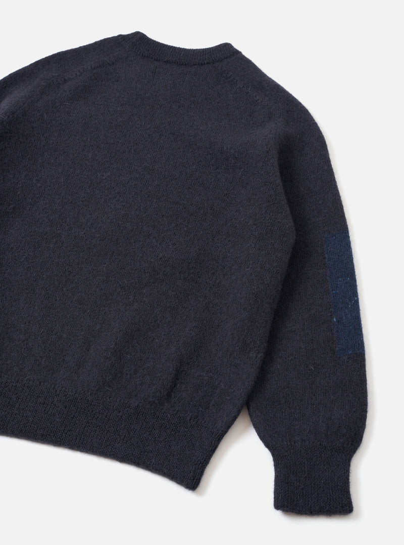 Back view of the Navy British Wool Lyon Crew sweater set on a clean white studio background. Showcases the relaxed fit design, seamless raglan shoulder seams, and textured marled navy British wool construction throughout the garment.